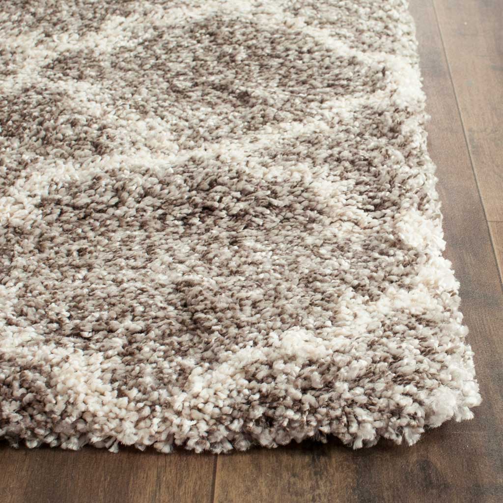 Plump gray and ivory shag fibers form a thick corner with a soft, cushioned edge.