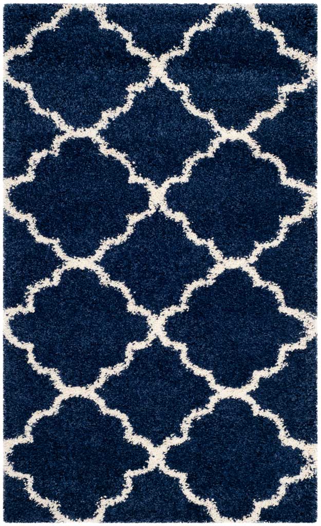 Small navy rug with bold ivory quatrefoils and deep shag