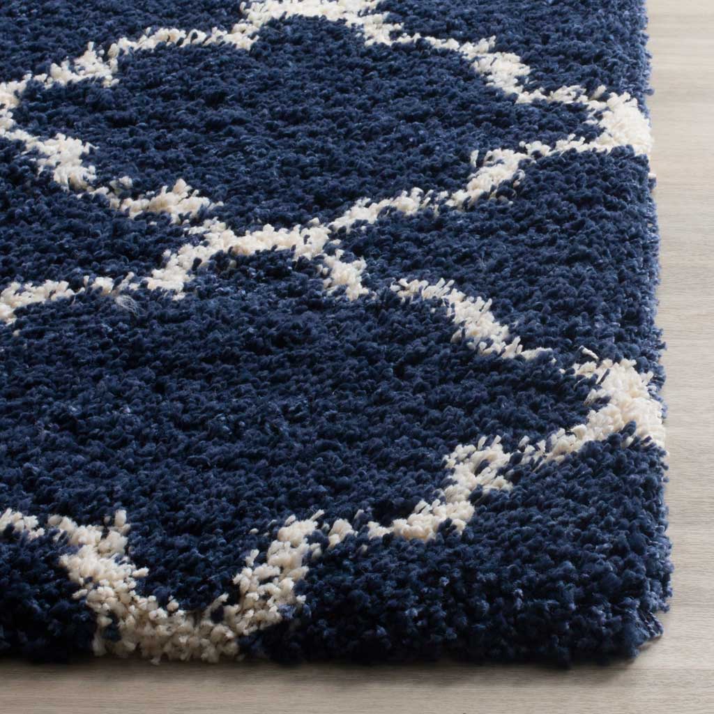 Thick navy shag and ivory trellis lines finish in a soft edge