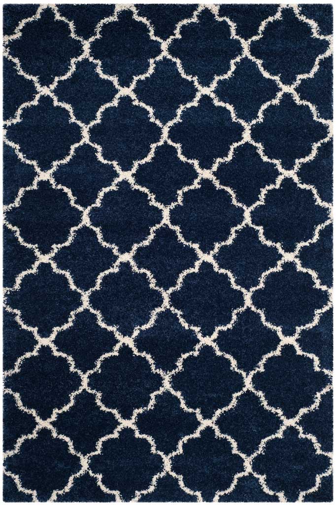 Plush navy pile divided by a delicate ivory quatrefoil trellis