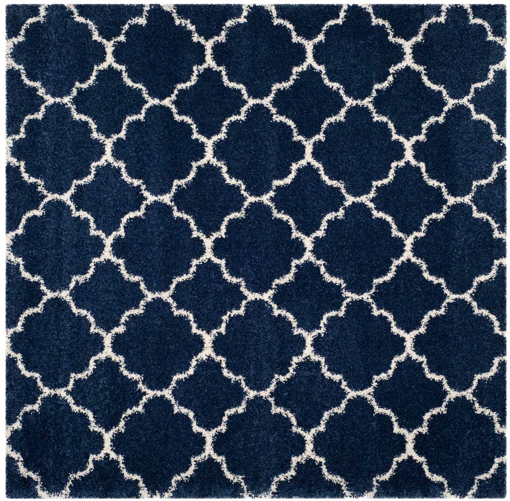 Square navy rug covered in repeating ivory quatrefoil outlines