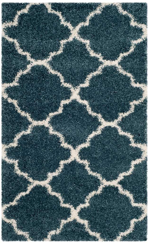 Small slate blue rug with bold ivory quatrefoil outlines