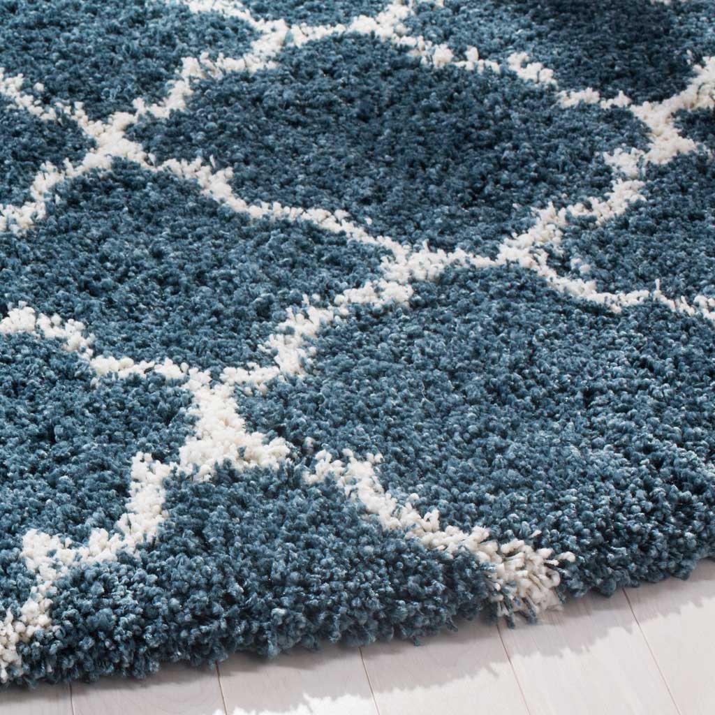 Blue shag and ivory quatrefoil lines meet at the rug's thick, inviting edge