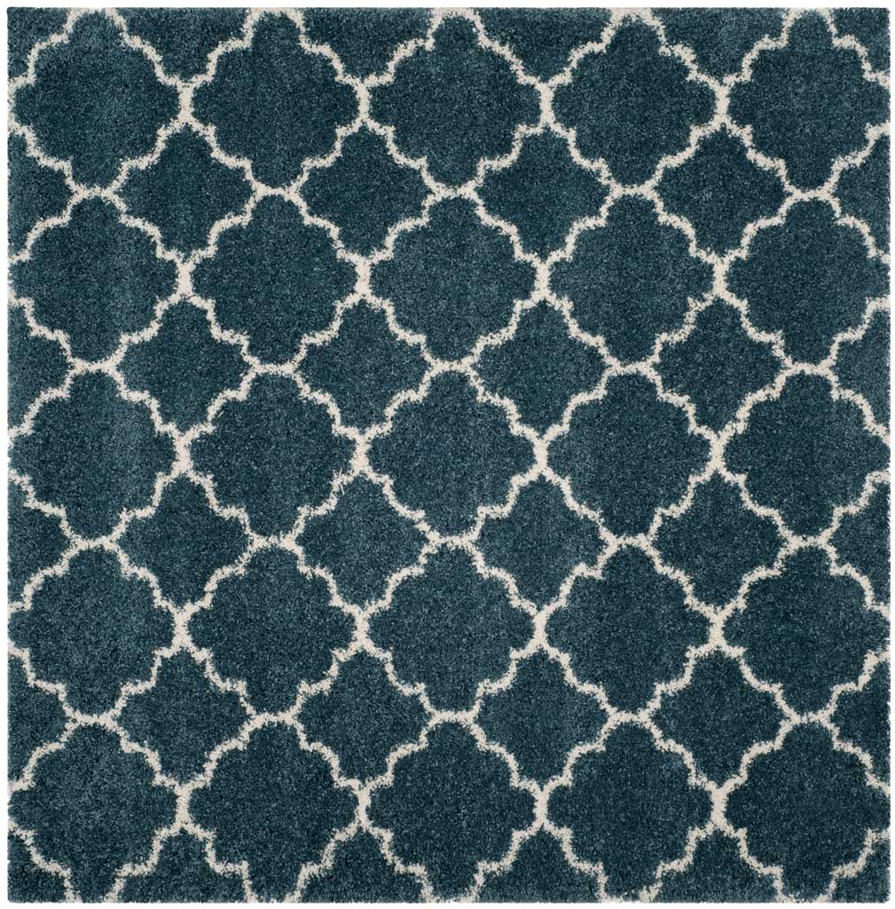Square slate blue rug patterned with repeating ivory quatrefoils