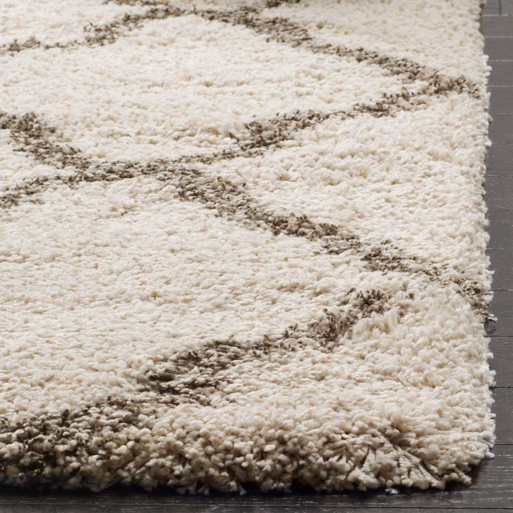Dense ivory pile meets gray curves along a plush finished edge