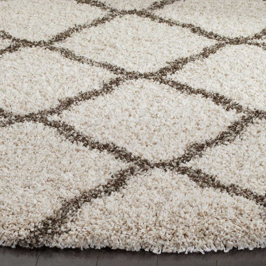 Raised gray lattice lines break up the soft ivory shag near the rug edge
