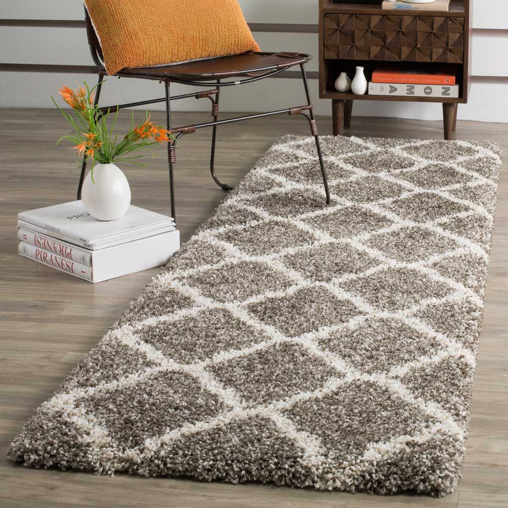 An airy ivory diamond pattern softens the dense gray shag of this runner.