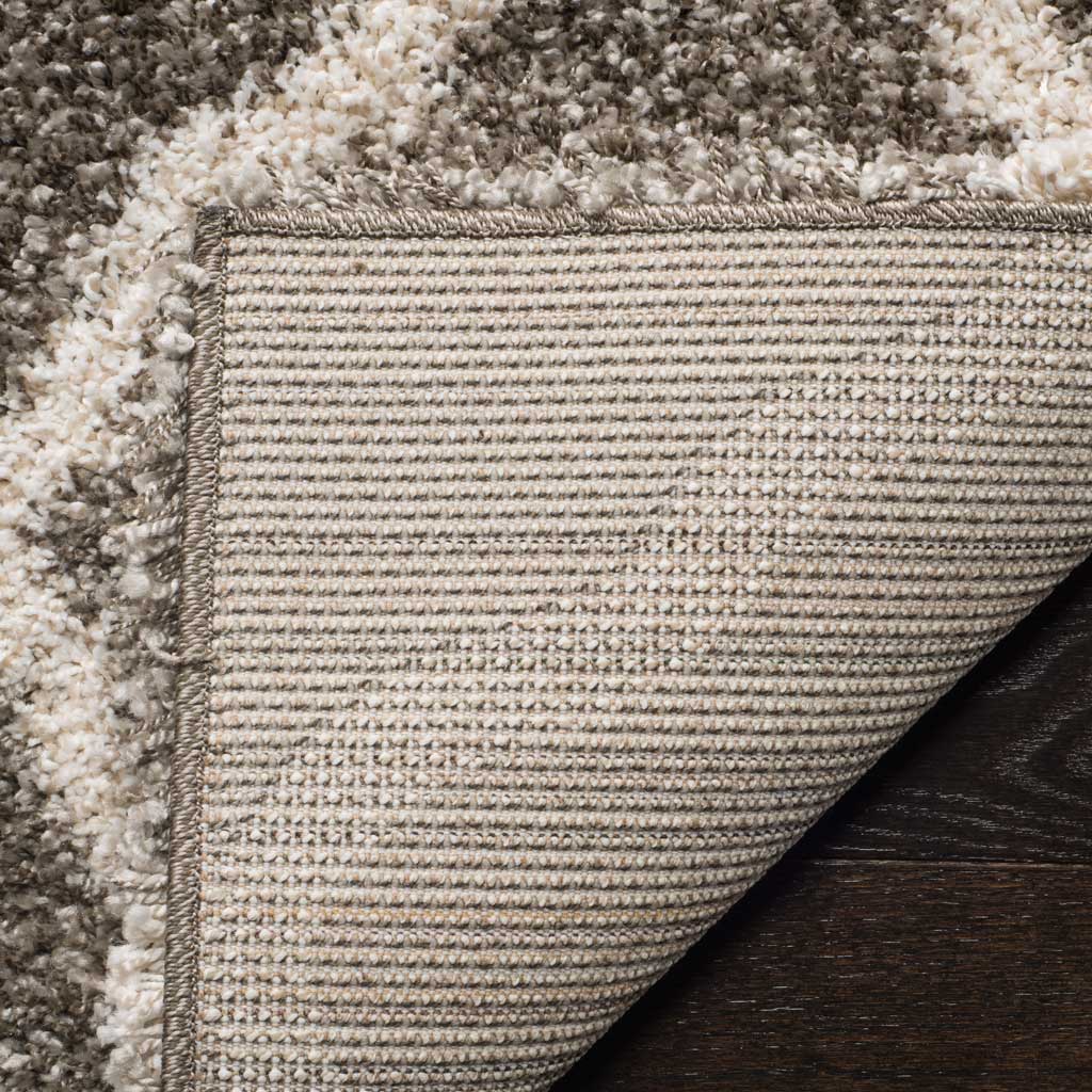 Woven underside and gray binding support the soft shag pile