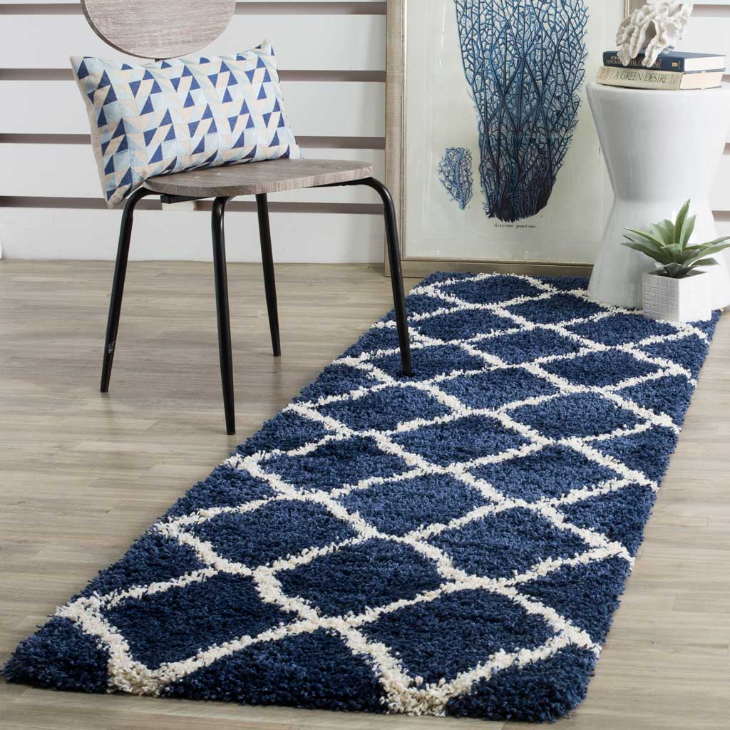 An ivory trellis makes a bold graphic contrast against this plush navy runner.