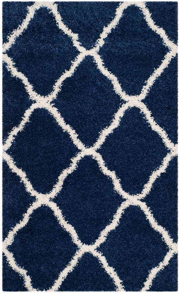 Small navy rug with bold ivory curved diamonds and plush pile