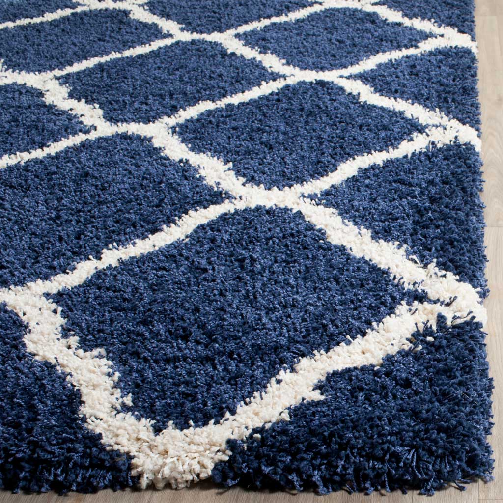 Thick navy and ivory fibers create a soft patterned edge