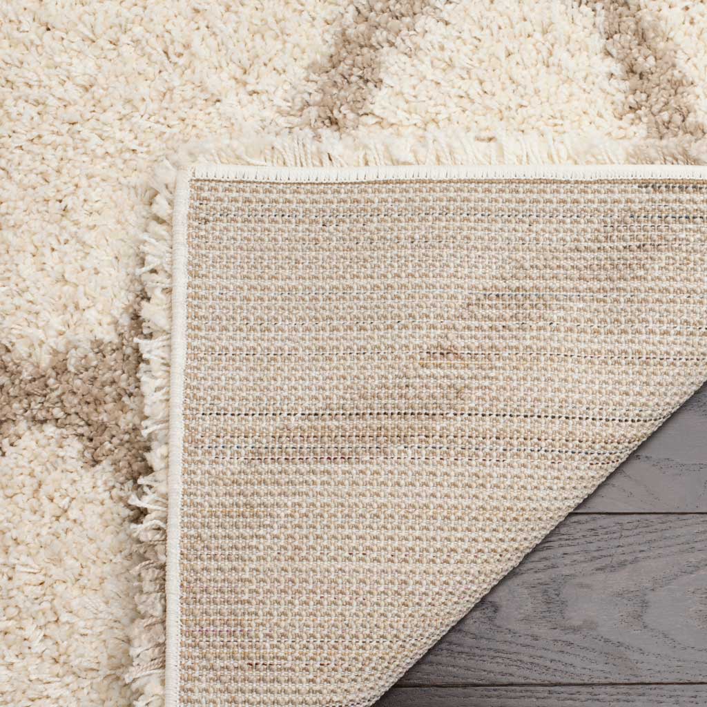 Woven underside and bound ivory edge support the plush rug