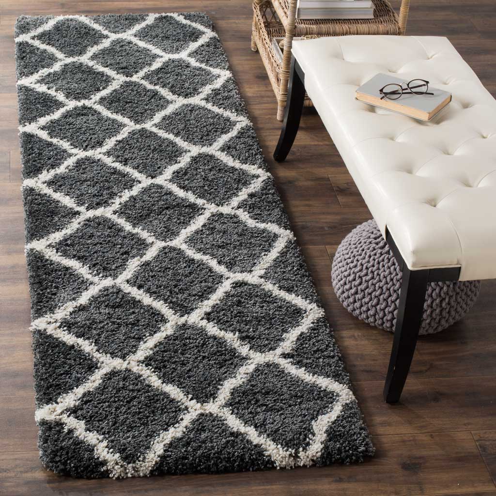 Crisp ivory trellis lines bring lively contrast to the plush dark gray runner.