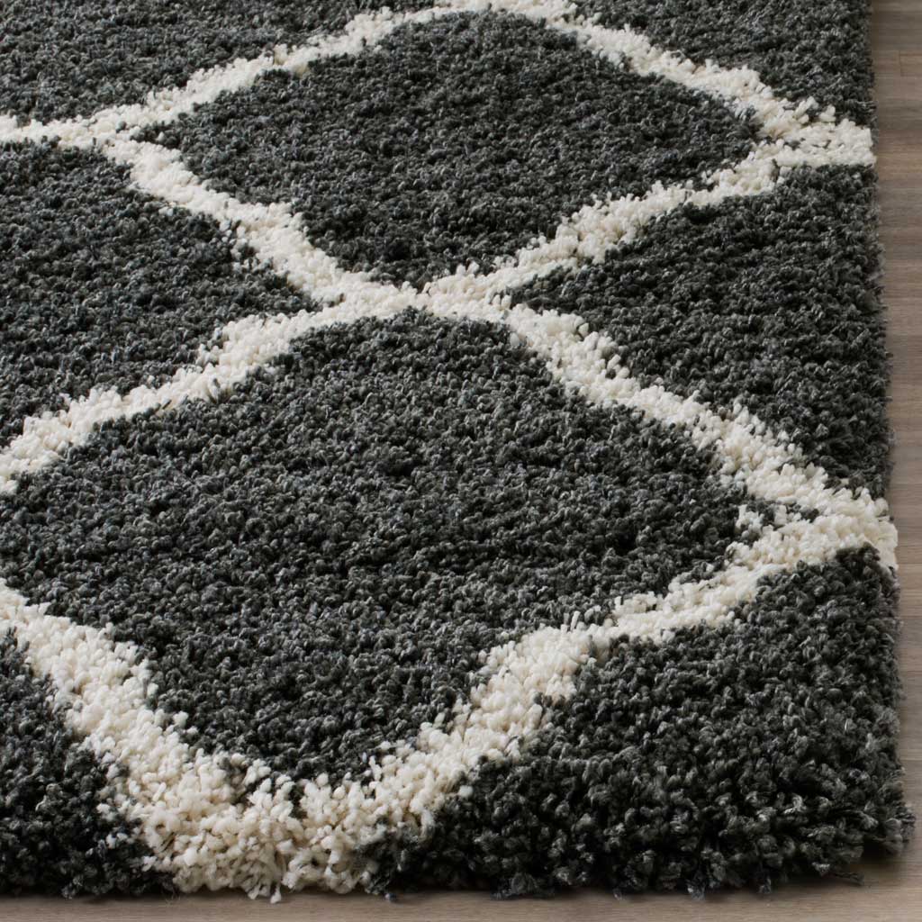 Dense charcoal pile meets thick ivory lattice lines at the edge