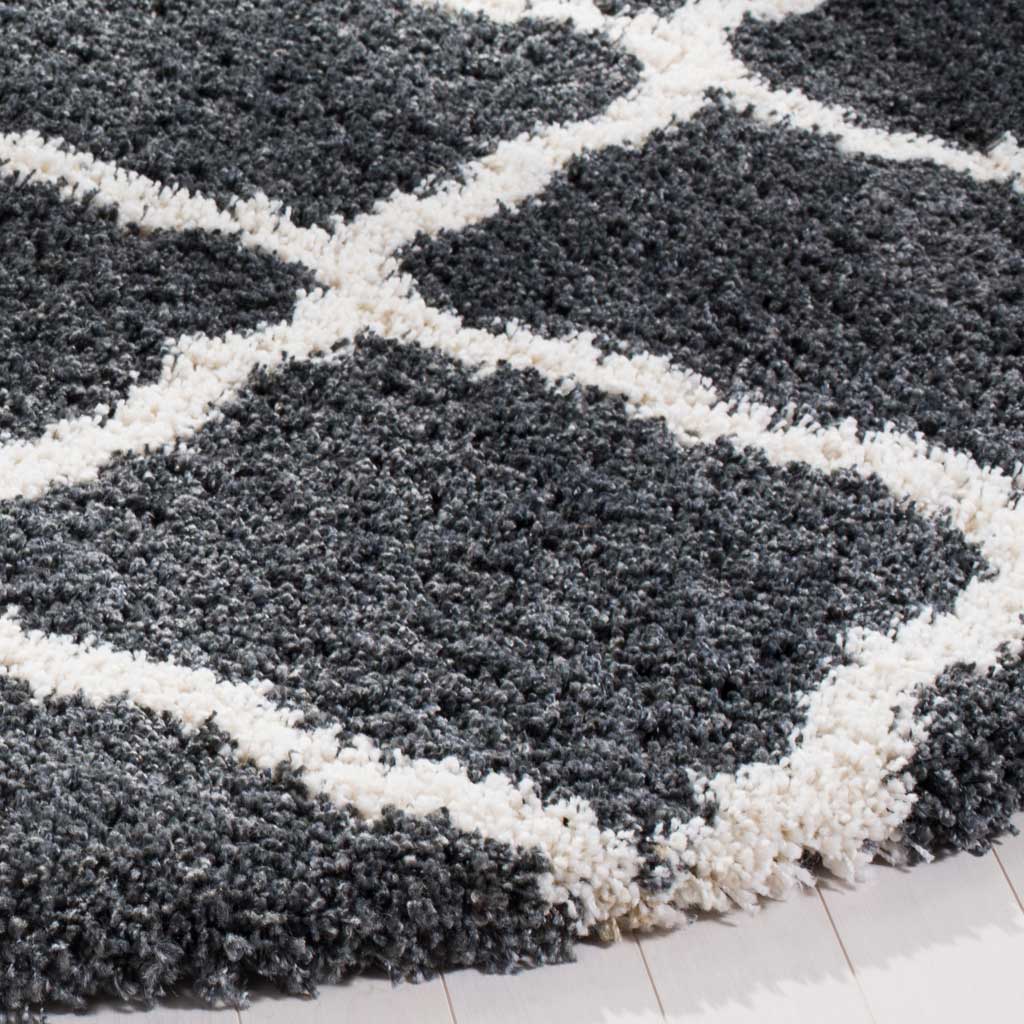 Thick charcoal shag meets ivory curved trellis lines at the rug's cushioned edge