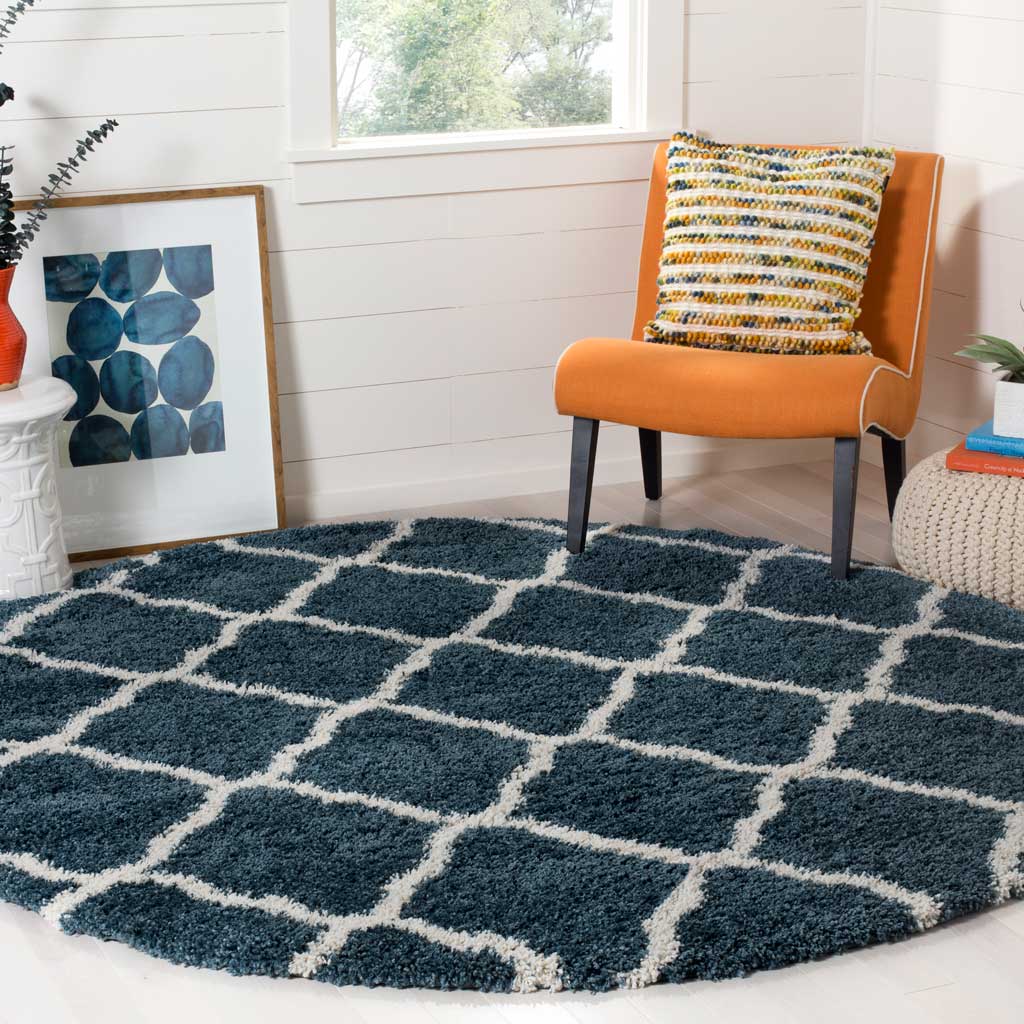 Ivory rounded diamonds brighten the deep blue pile of this cushioned round rug