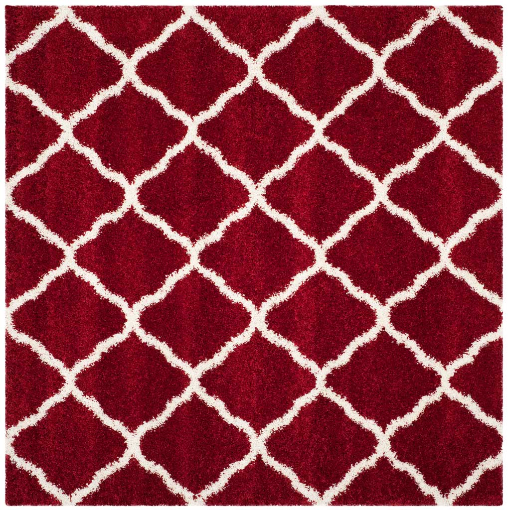 Square red rug patterned with interlocking ivory curved diamonds