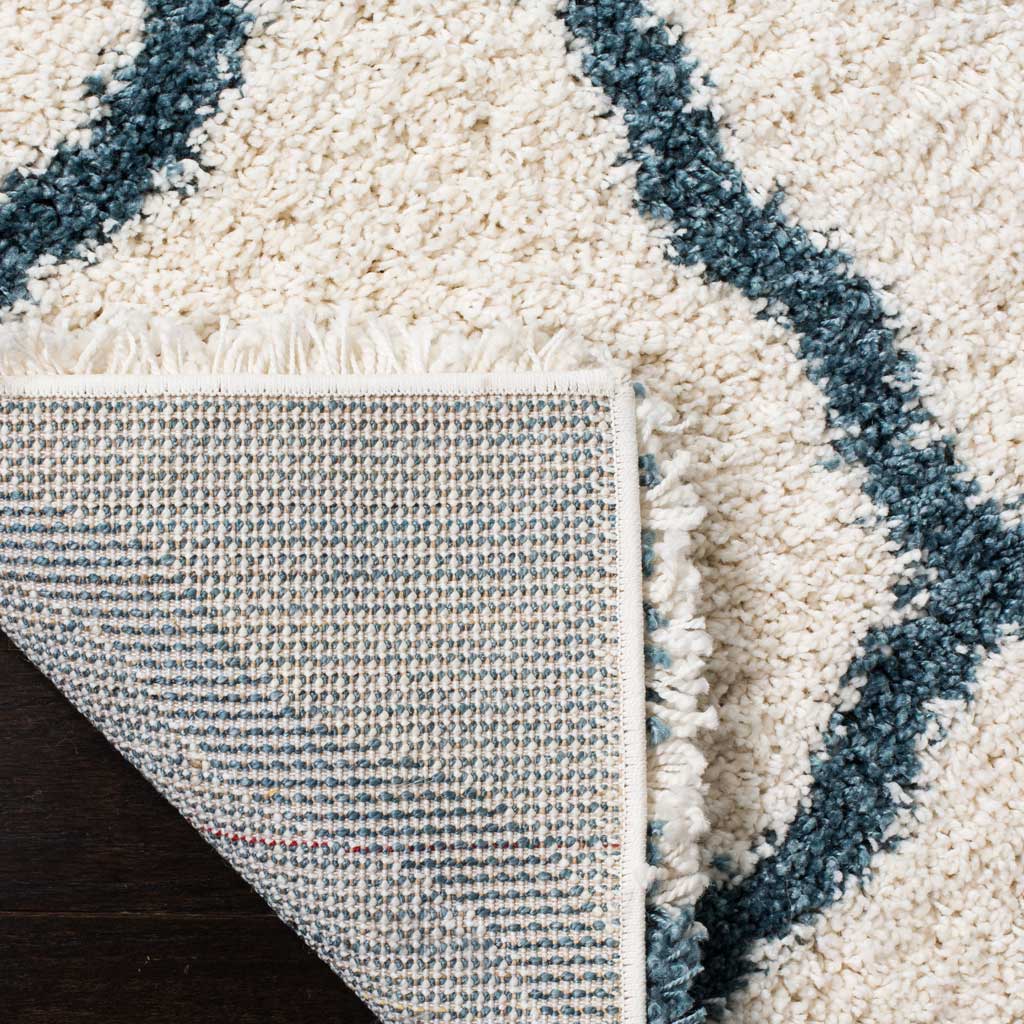 Woven underside and bound edge support the blue-patterned shag