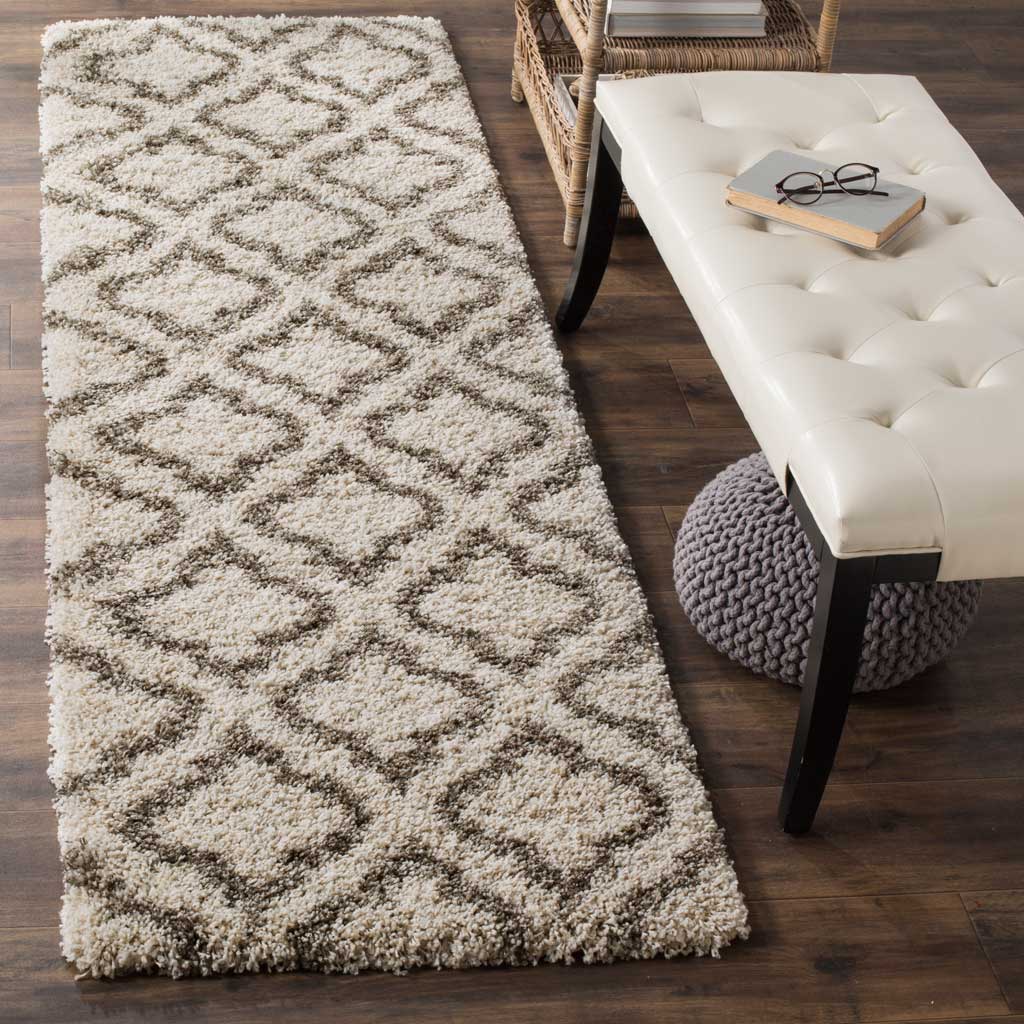 A curving gray trellis adds rhythmic contrast across this cozy ivory runner.