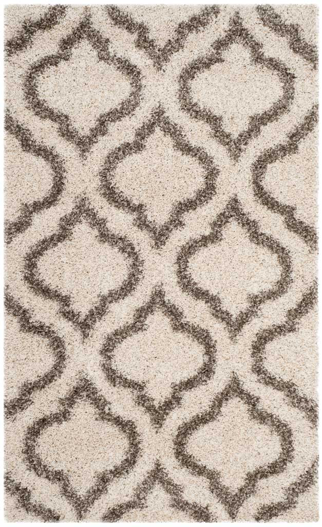Small ivory rug with sweeping gray ornamental lines