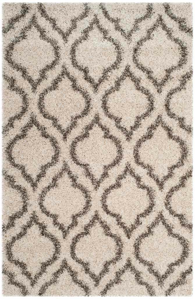 Ivory rectangular shag rug with bold gray arabesque motifs
