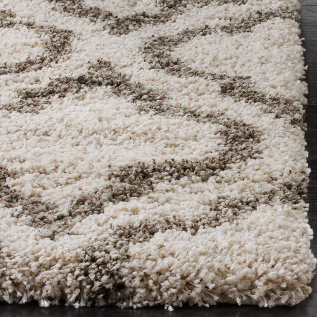 Lofty ivory fibers meet the gray trellis along a thick finished edge