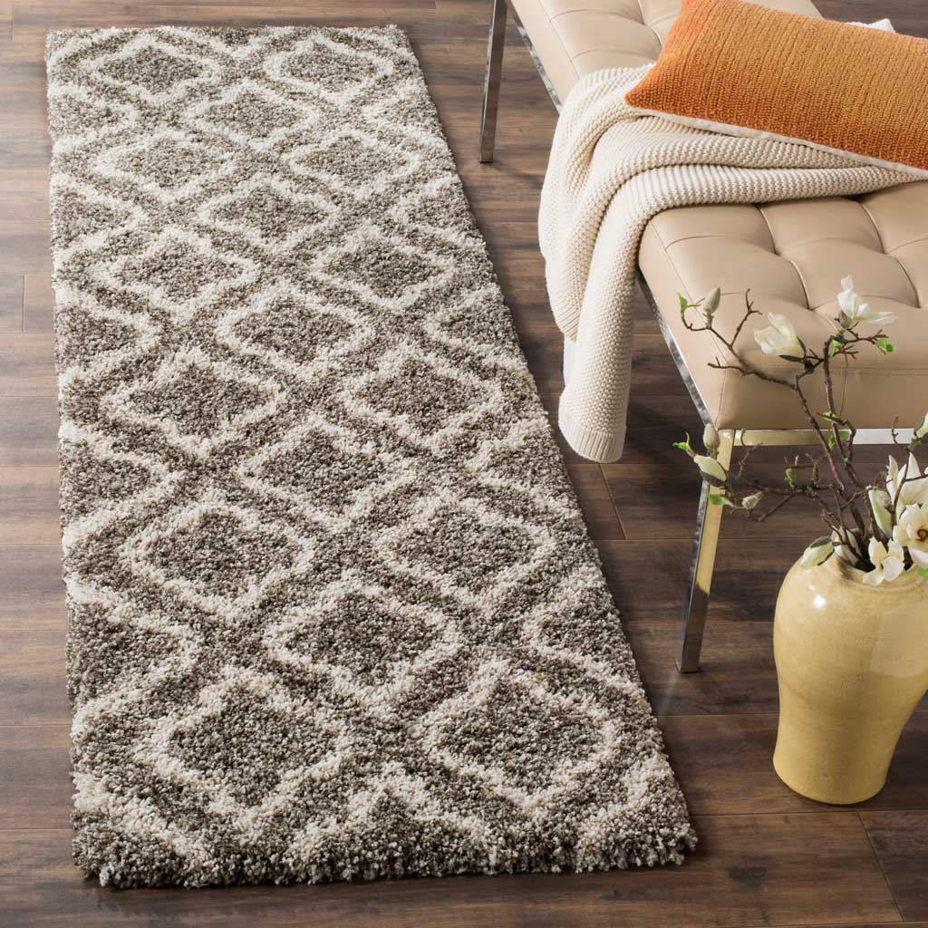 Ivory curving motifs add contrast across the thick gray pile of this elegant runner.