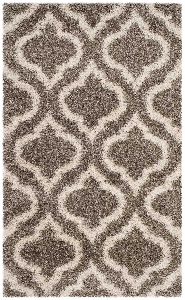Small gray rug with a striking ivory curved trellis design