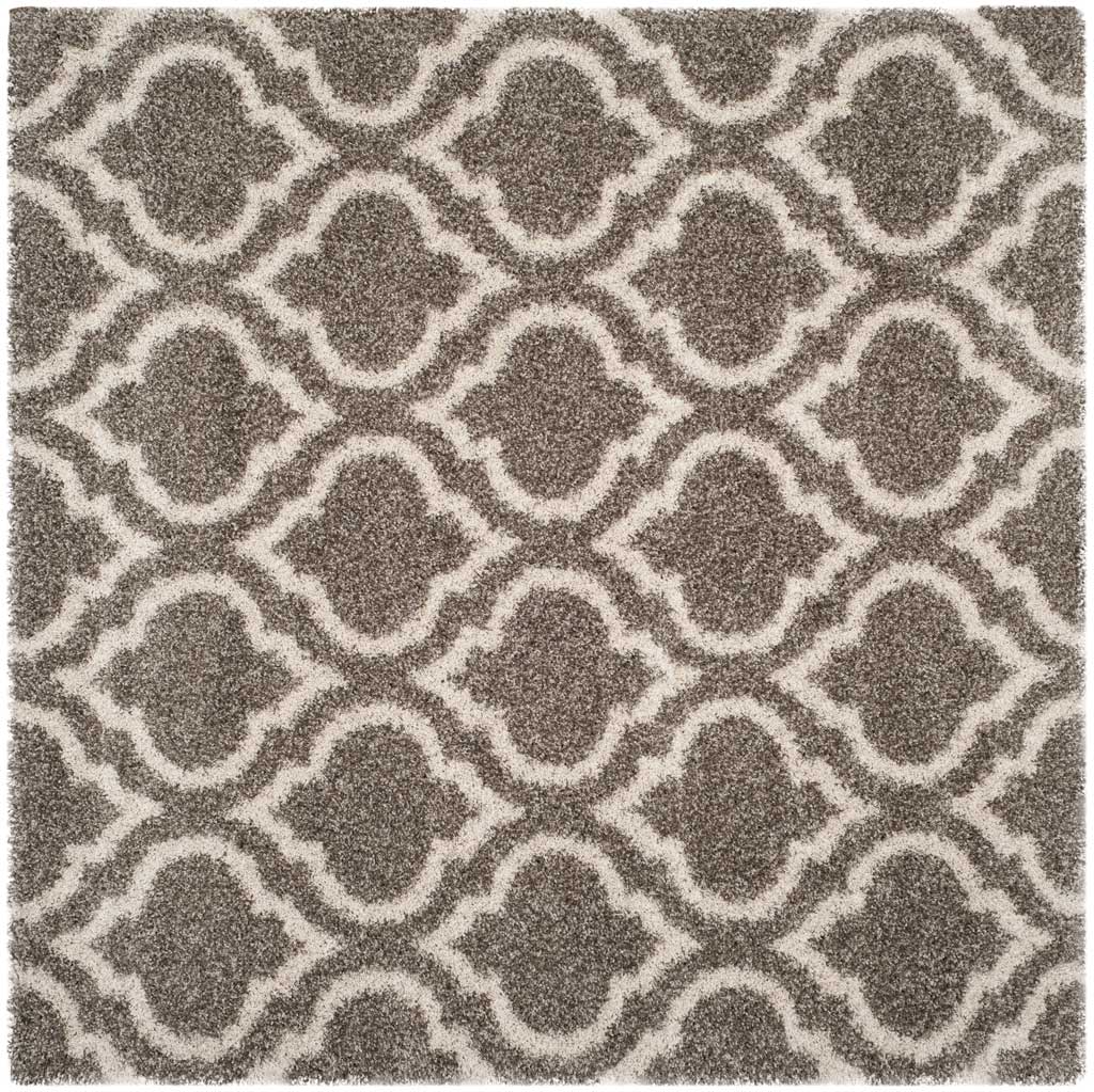 Square gray rug filled with ivory-outlined curved motifs