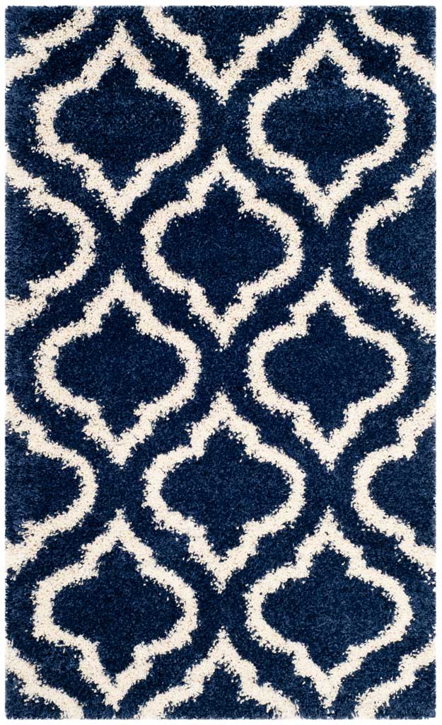 Small navy shag rug with oversized ivory curved trellis lines