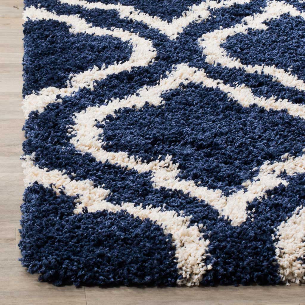 Thick navy and ivory fibers create a plush patterned edge