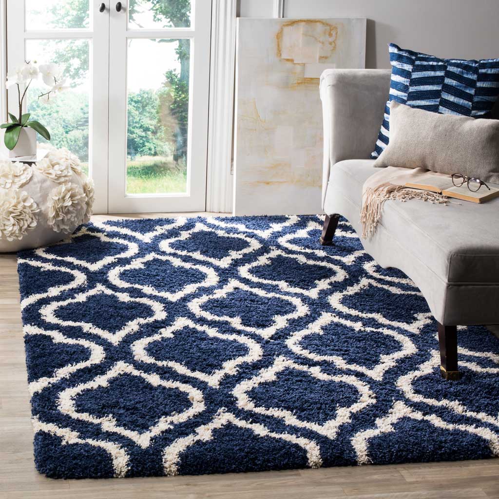 Navy ornamental shag rug adds bold pattern beneath pale seating