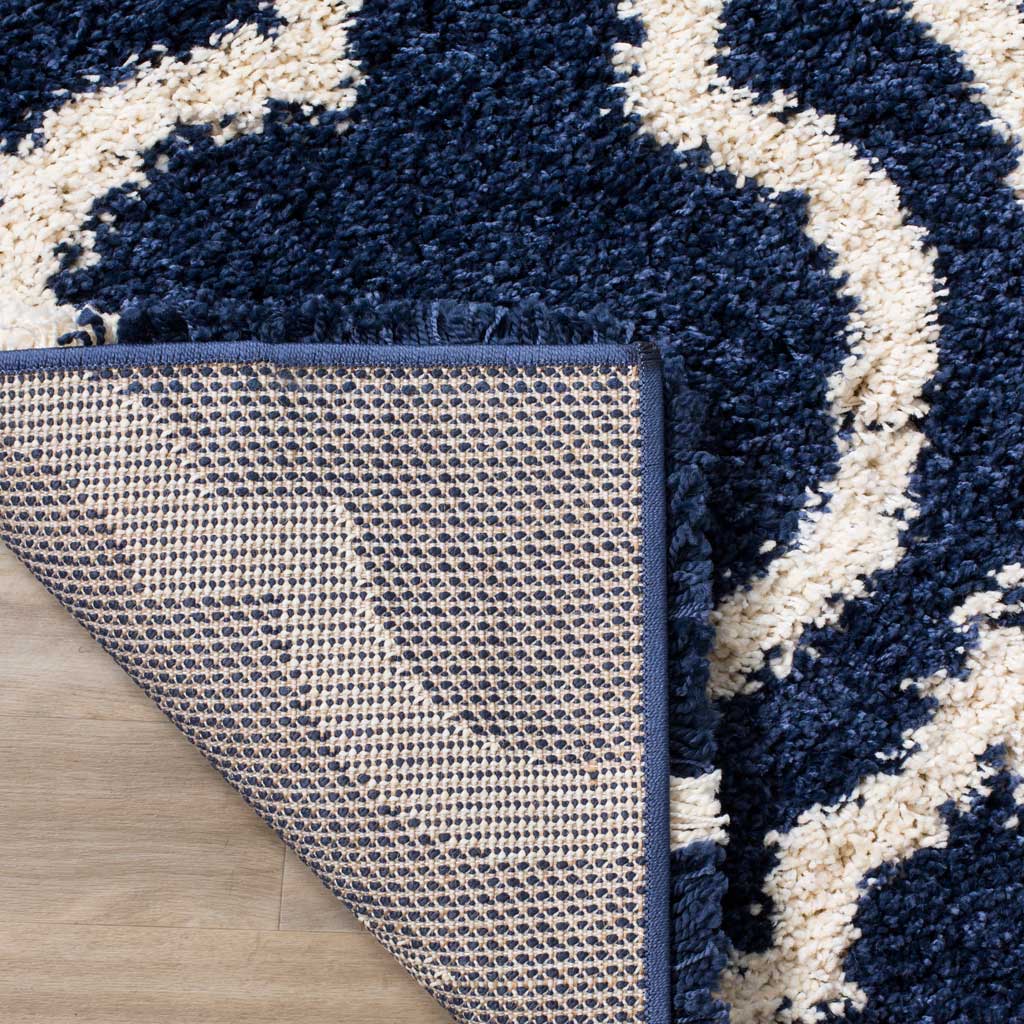 Woven underside and navy binding support the shag surface