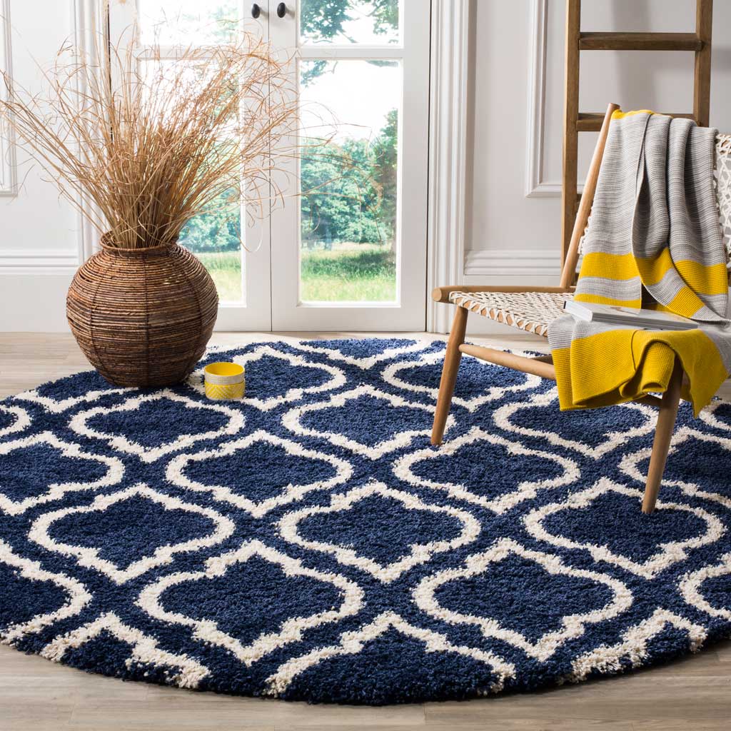 Bold navy-and-ivory ogee motifs bring plush comfort and graphic energy underfoot