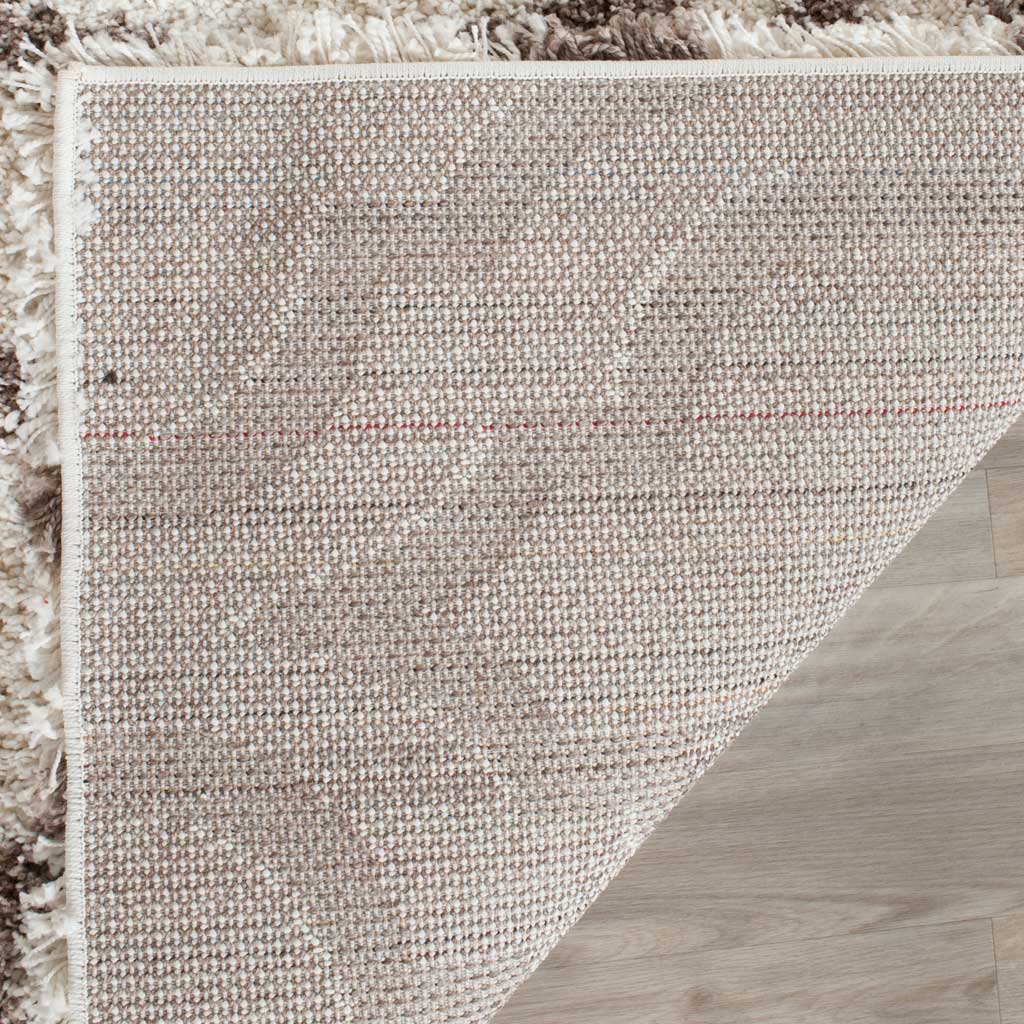 Woven underside and bound ivory edge support the soft shag