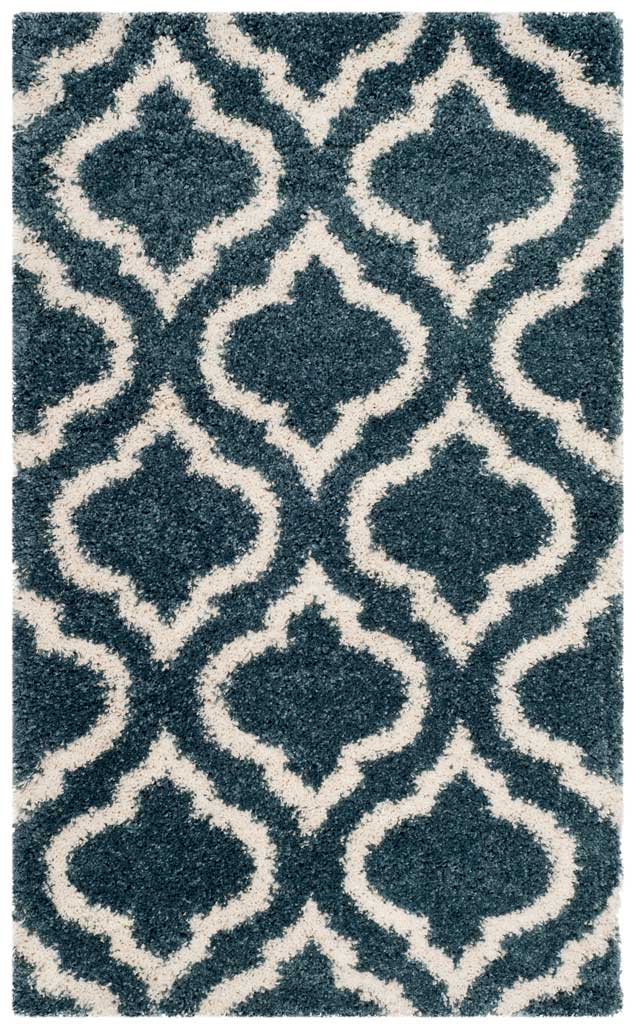 Small slate blue rug with generous ivory arabesque shapes