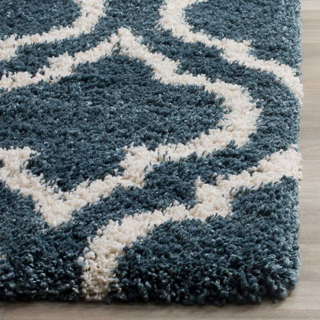 Thick blue shag meets an ivory curved line at the rug's edge