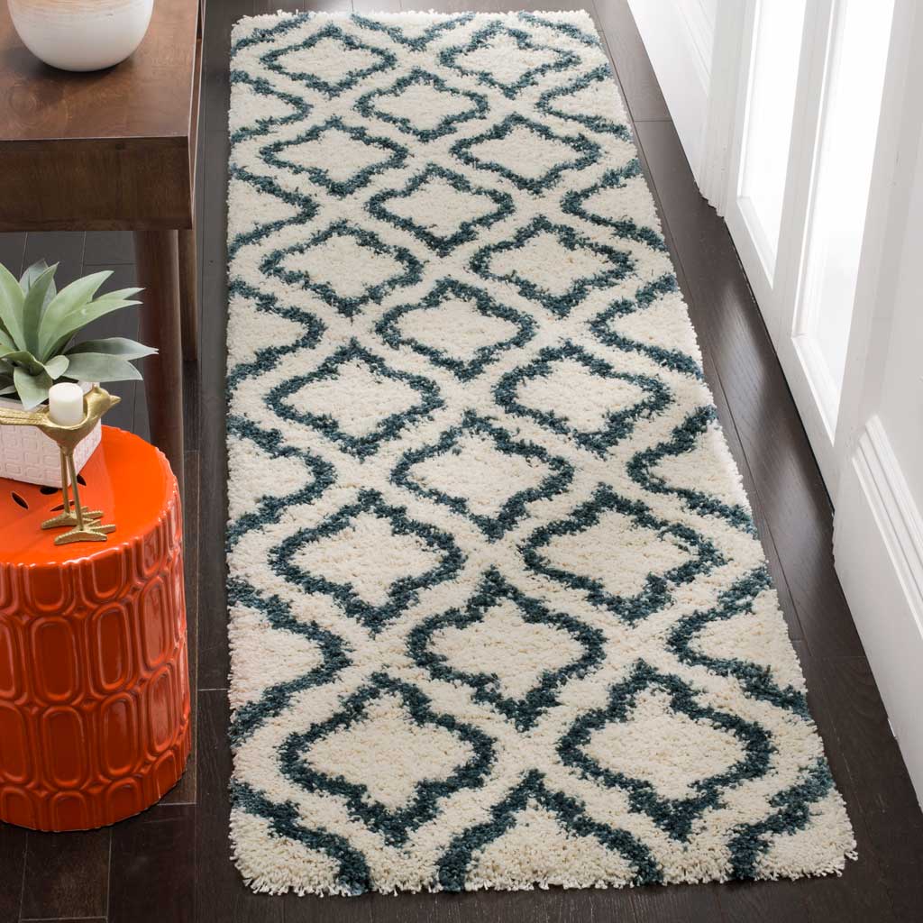 Steel blue trellis lines bring bold contrast to the ivory pile of this soft runner.