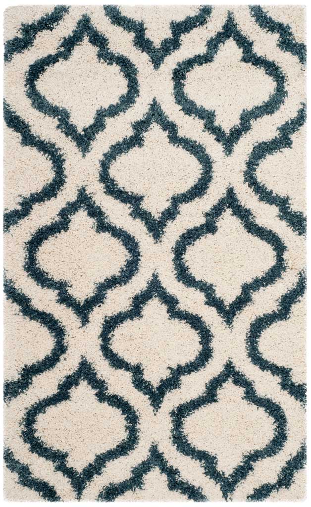 Small ivory rug with a striking steel blue curved lattice