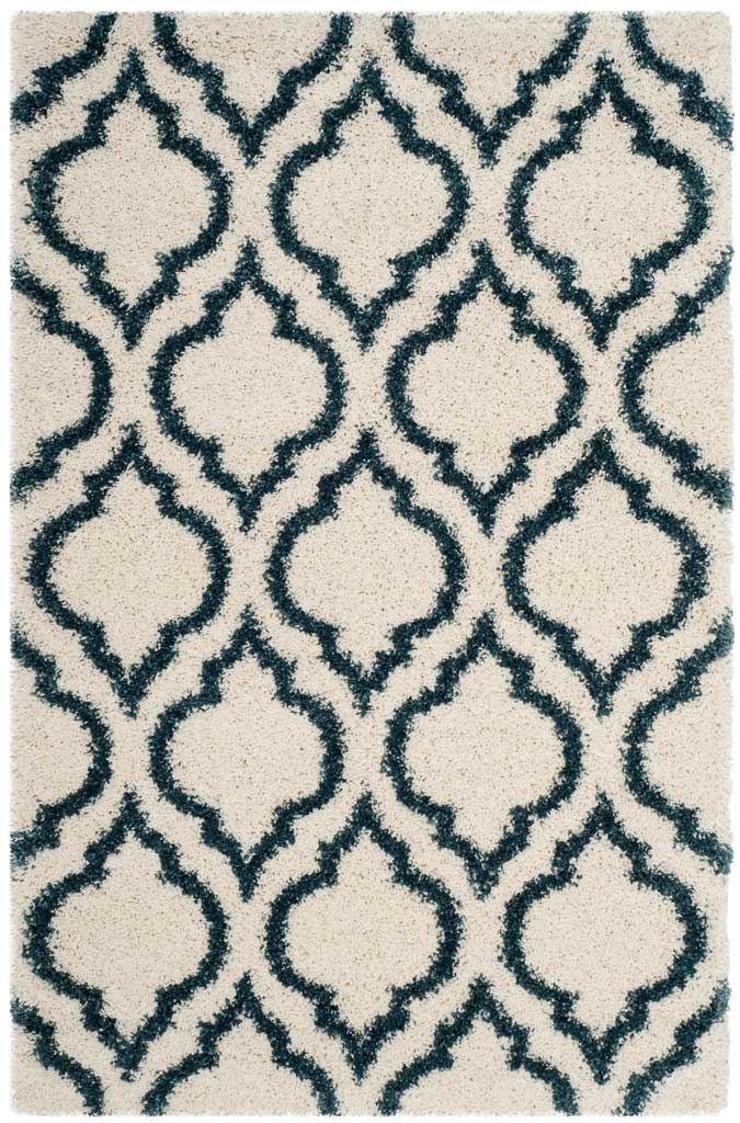 Ivory rectangular shag rug patterned with blue ornamental shapes