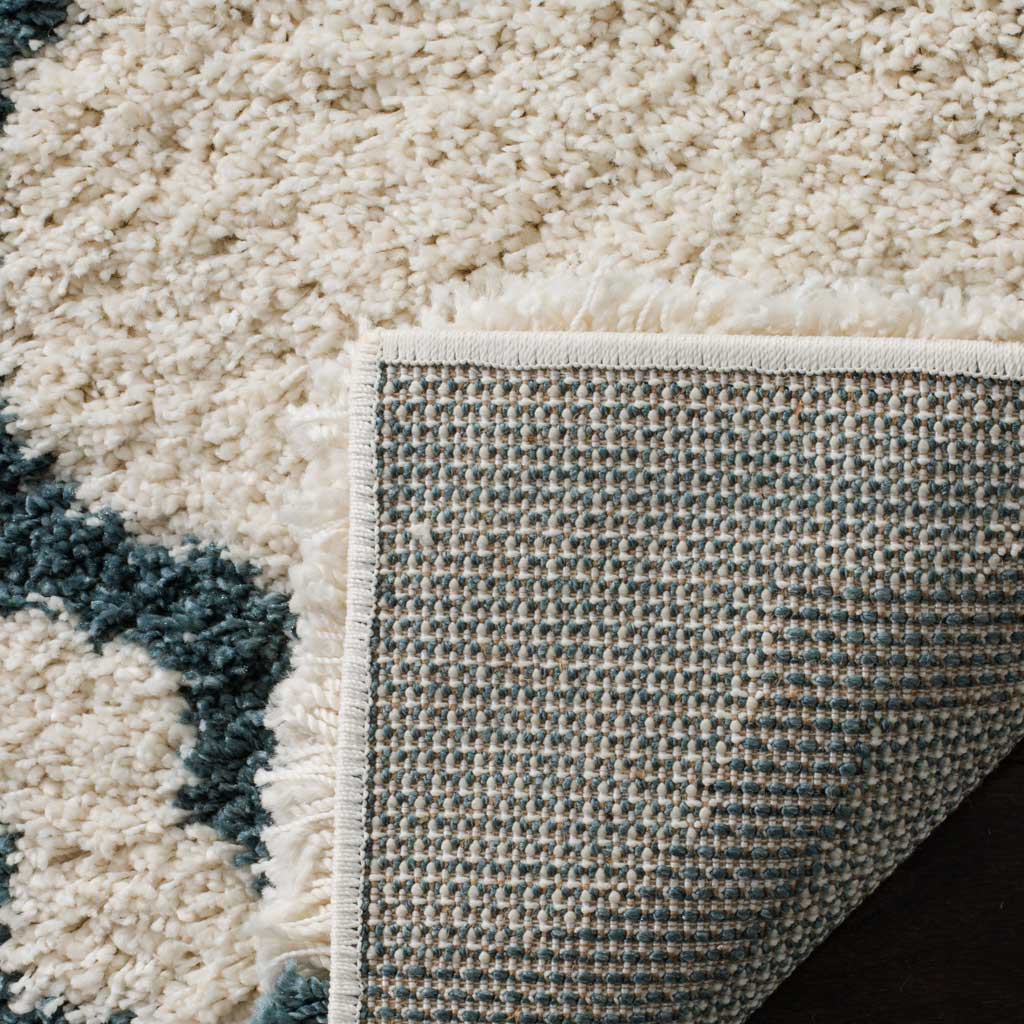 Woven backing and ivory binding finish the blue-patterned shag