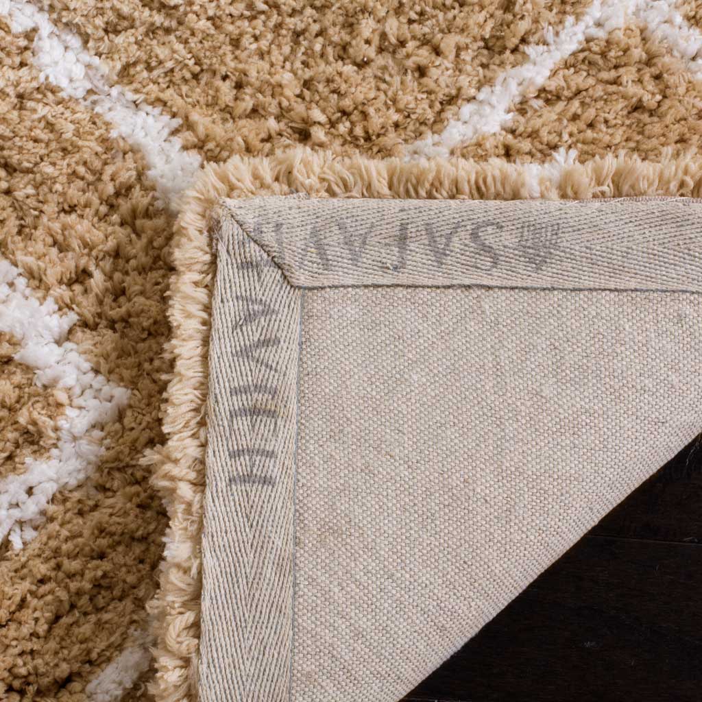 Woven backing and a stitched border add structure beneath the plush beige and ivory rug