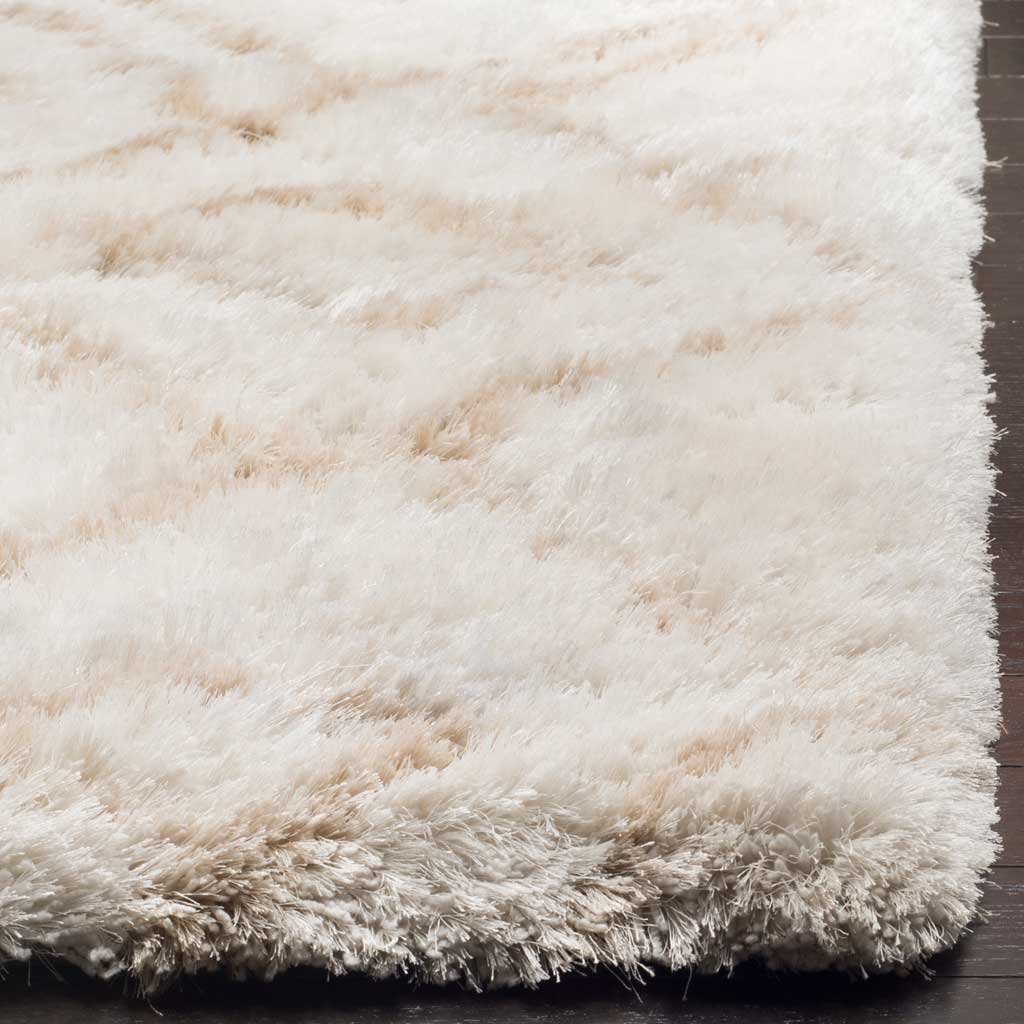An extra-plush ivory pile meets faint beige lines along the thick, softly finished edge