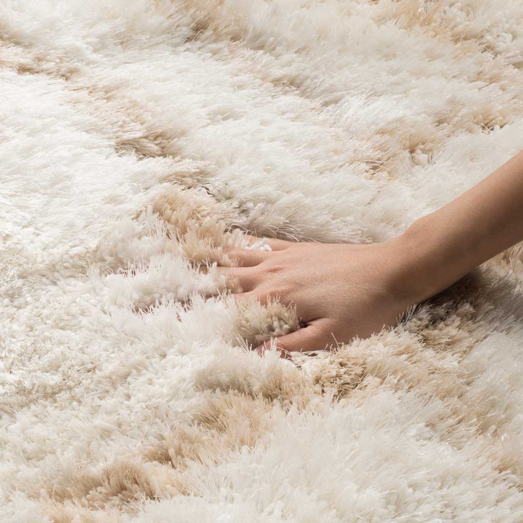 Dense ivory and beige shag has a plush, touchable texture that feels cozy underfoot