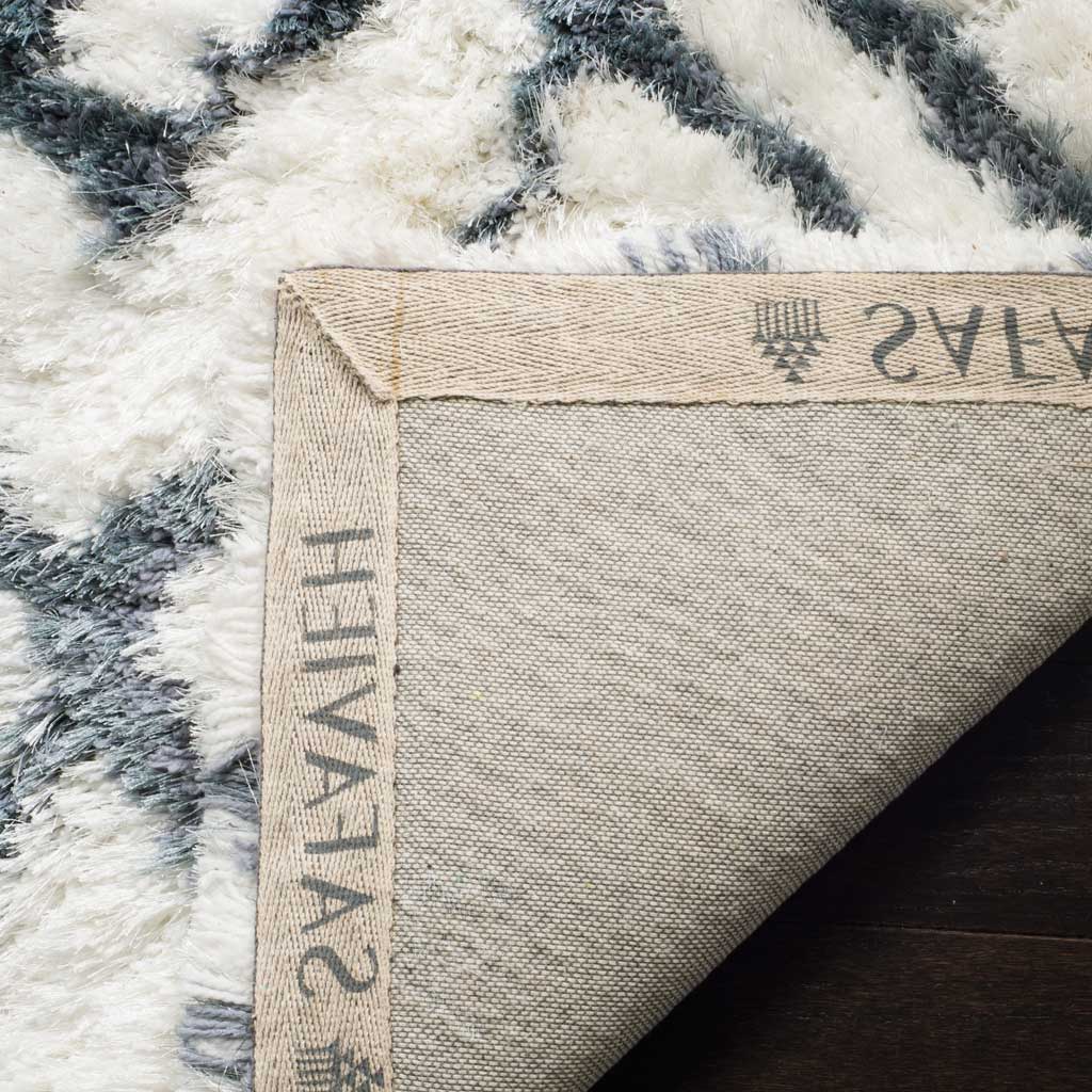 A woven fabric underside and finished binding support the ivory and blue shag
