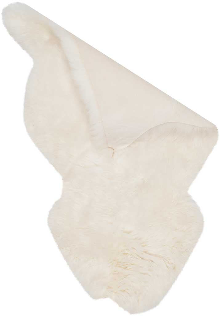Smooth natural hide peeks out beneath the folded ivory fleece of this sheepskin rug.