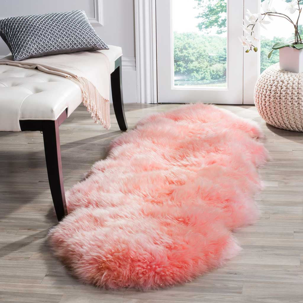 Fluffy pink sheepskin makes a playful accent on light wood floors