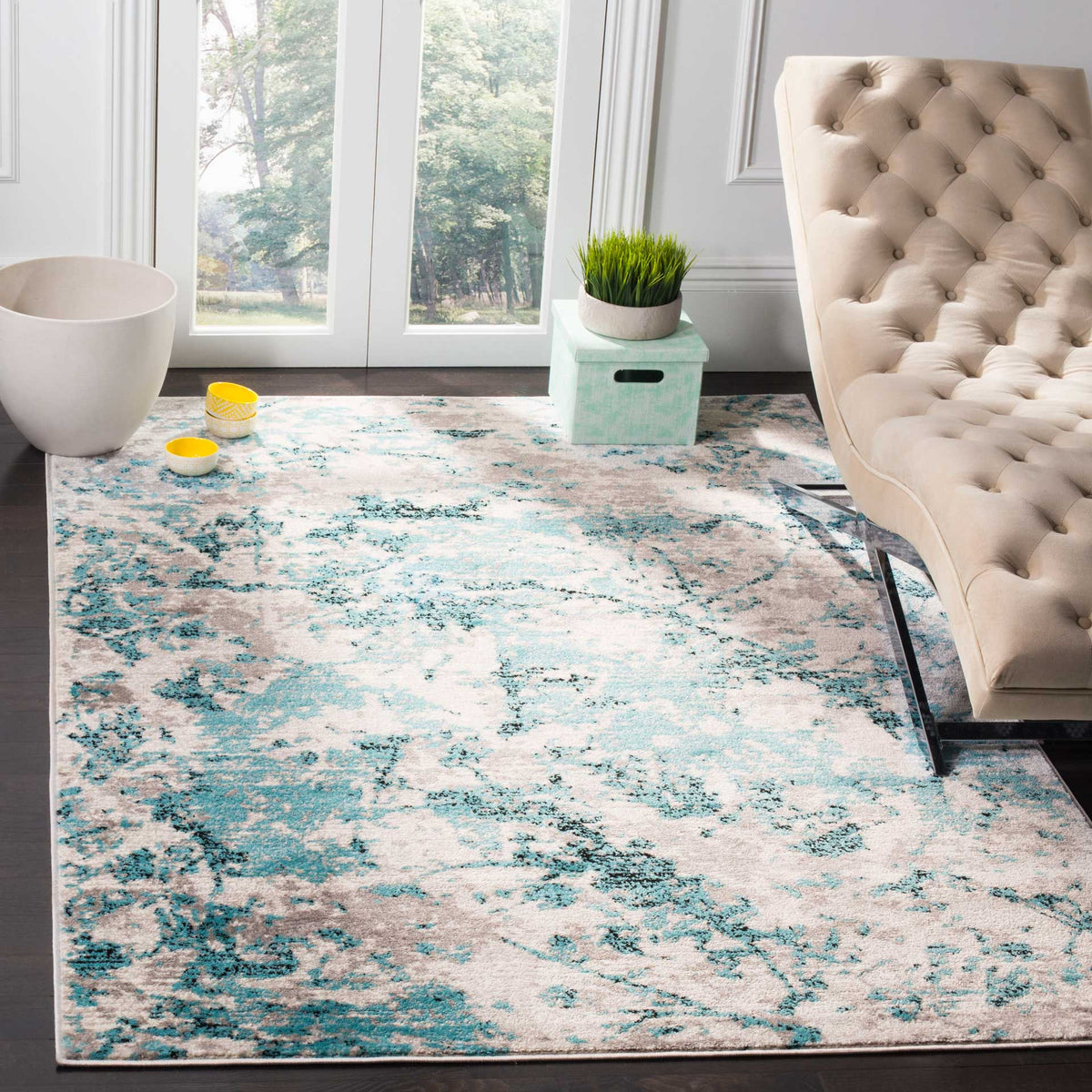 A blue and ivory abstract rug adds cool color and inviting texture to a bright living space