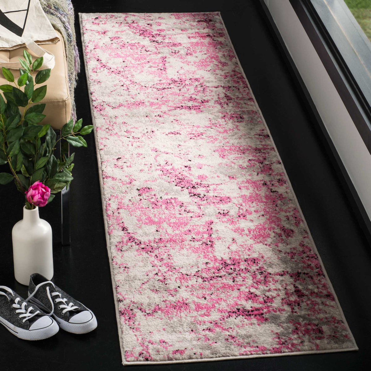 Bright pink and ivory hues give this slim abstract runner a lively, inviting look.