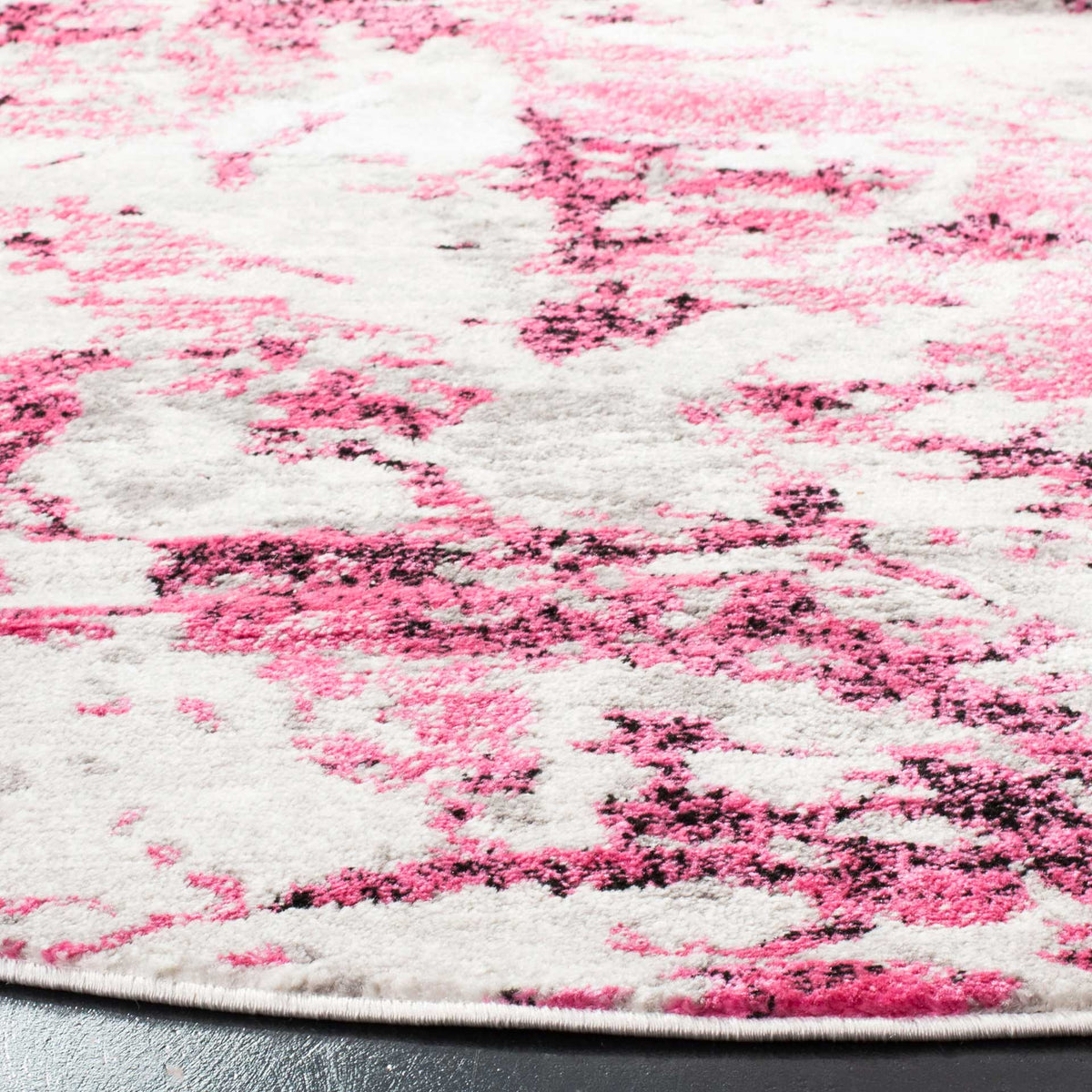 Textured pink and ivory pile reveals mottled color and a neatly bound edge.